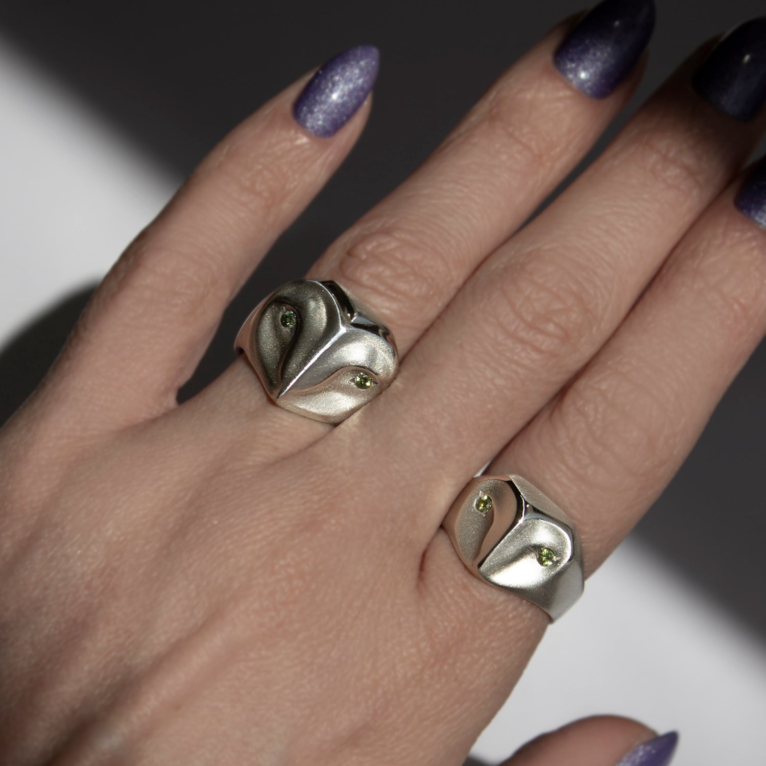 Handmade owl rings on hand in sterling silver with sage green sapphires, part of the animal jewelry collection by Elina Gleizer.