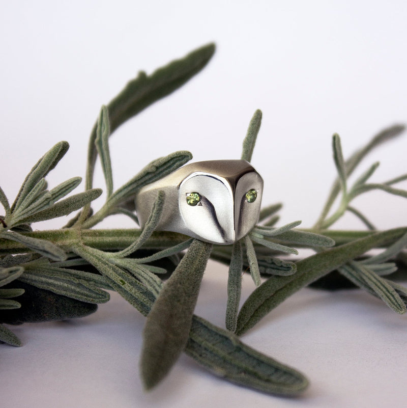 Handmade owl ring in sterling silver with sage green sapphires, part of the animal jewelry collection by Elina Gleizer.